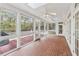 Screened in porch with brick flooring, ceiling fans, and multiple windows providing natural light at 220 Spring Branch Dr, Canton, GA 30115