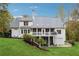 Rear exterior showing a spacious yard, deck, and screened-in porch at 220 Spring Branch Dr, Canton, GA 30115