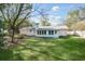 Green backyard featuring a brick house, white trim, and a white picket fence at 1830 Mayfield Rd, Alpharetta, GA 30009