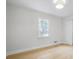 Bright bedroom featuring light wood flooring, a white ceiling fan, and a closet at 1830 Mayfield Rd, Alpharetta, GA 30009