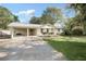 Inviting exterior view of house with carport, mature trees and landscaped front lawn at 1830 Mayfield Rd, Alpharetta, GA 30009