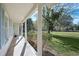 Covered porch with pillars offering a pleasant view of the well-maintained yard at 1830 Mayfield Rd, Alpharetta, GA 30009