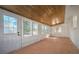 Bright sunroom with wood ceiling, brick accent wall, and multiple windows at 1830 Mayfield Rd, Alpharetta, GA 30009