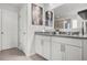 Bathroom with double granite vanity, framed mirrors, and plentiful lighting at 3210 Ancoats St, Douglasville, GA 30135