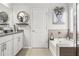 Bright bathroom featuring double sinks, granite counters, and a soaking tub, creating a spa-like experience at 3210 Ancoats St, Douglasville, GA 30135