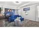 Elegant bedroom with a comfortable bed, blue velvet settee, and modern decor, creating a serene and stylish atmosphere at 3210 Ancoats St, Douglasville, GA 30135
