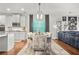 Elegant dining area with modern lighting, stylish seating, and seamless flow to kitchen at 3210 Ancoats St, Douglasville, GA 30135