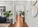 Bright hallway with hardwood floors, decorative wall art, and a view into the living area at 3210 Ancoats St, Douglasville, GA 30135