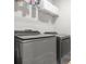 The laundry room features modern grey appliances with overhead shelving at 3210 Ancoats St, Douglasville, GA 30135