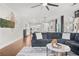 Open concept living room with stylish furniture, a cozy sectional sofa, and seamless transition to the well-lit kitchen at 3210 Ancoats St, Douglasville, GA 30135