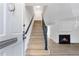 Inviting foyer with light wood staircase, neutral walls, and a glimpse of a cozy fireplace at 10 Chaumont Nw Sq, Atlanta, GA 30327