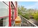Balcony view shows outdoor scenery, a table and chairs, and the red-framed windows at 572 Edgewood Ne Ave # 306, Atlanta, GA 30312