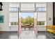 Balcony features a table and chairs, a scenic outdoor view through large windows and red framed doors at 572 Edgewood Ne Ave # 306, Atlanta, GA 30312