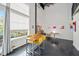 Bright dining room features a table with yellow chairs and tall windows with natural light at 572 Edgewood Ne Ave # 306, Atlanta, GA 30312