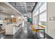Sunlit living area with a spiral staircase, modern kitchen, dining area, and large windows at 572 Edgewood Ne Ave # 306, Atlanta, GA 30312