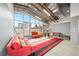 Open living room features high ceilings, expansive windows, exposed beams, and red accent rug at 572 Edgewood Ne Ave # 306, Atlanta, GA 30312