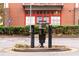 Parking lot entry system with landscaped bushes and a building with red trim in the background at 572 Edgewood Ne Ave # 306, Atlanta, GA 30312