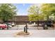 Gated parking lot featuring numerous parked cars with mature trees in the background on a sunny day at 572 Edgewood Ne Ave # 306, Atlanta, GA 30312
