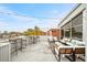 Bright rooftop patio features multiple seating areas, bar, and city views on a beautiful day at 572 Edgewood Ne Ave # 306, Atlanta, GA 30312