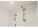Close-up of the tile shower showcasing the adjustable showerhead and built-in storage at 572 Edgewood Ne Ave # 306, Atlanta, GA 30312