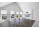 Spacious living room with tall ceilings, modern fireplace, large windows, and hardwood style flooring at 124 Pearl St, Woodstock, GA 30188