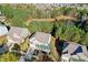 An aerial view of the home with a pond, mature trees, and neighboring houses in a serene setting at 3213 Blackley Old, Douglasville, GA 30135