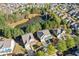 This is an aerial view of a home nestled in a residential neighborhood with manicured lawns and tree coverage at 3213 Blackley Old, Douglasville, GA 30135