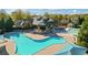 Aerial view of a resort-style pool, showcasing clear blue water, lounge areas, and lush landscaping at 3213 Blackley Old, Douglasville, GA 30135