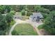 Aerial view of house with large backyard, detached garage, and long driveway at 695 Old Peachtree Rd, Lawrenceville, GA 30043