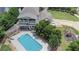 An aerial view showcasing a house, pool, pergola, and playground in the backyard at 695 Old Peachtree Rd, Lawrenceville, GA 30043