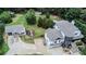 Aerial view of a two-story house, detached garage, and expansive backyard with playground at 695 Old Peachtree Rd, Lawrenceville, GA 30043