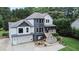 Exterior of a two-story house with gray and white siding, a large garage, and a deck at 695 Old Peachtree Rd, Lawrenceville, GA 30043