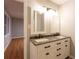 Updated bathroom with double vanity and a large mirror at 100 Lakeside Dr, Covington, GA 30016