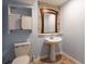 Basement bathroom with pedestal sink and toilet at 100 Lakeside Dr, Covington, GA 30016