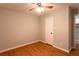 Hardwood floor bedroom with ceiling fan and closet at 100 Lakeside Dr, Covington, GA 30016