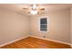 Hardwood floor bedroom with window and ceiling fan at 100 Lakeside Dr, Covington, GA 30016
