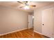 Bright bedroom featuring hardwood floors and ceiling fan at 100 Lakeside Dr, Covington, GA 30016