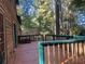 Spacious deck with wooden railings, steps, and a view of the wooded area at 100 Lakeside Dr, Covington, GA 30016