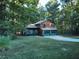 Ranch style home with wood siding, two-car garage, and a spacious yard at 100 Lakeside Dr, Covington, GA 30016