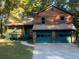 Two-story house with wood siding, green trim, and a two-car garage at 100 Lakeside Dr, Covington, GA 30016