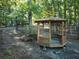 Wooden gazebo with a bench, located in a wooded backyard setting at 100 Lakeside Dr, Covington, GA 30016