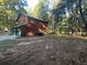 Rustic house exterior with a two-car garage and landscaping at 100 Lakeside Dr, Covington, GA 30016