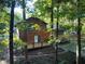 Back of house showcasing wooden exterior, deck, and private wooded setting at 100 Lakeside Dr, Covington, GA 30016