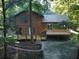 Back of house with large deck and wooded area at 100 Lakeside Dr, Covington, GA 30016