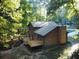 Two-story house with wooden siding, deck, and wooded backdrop at 100 Lakeside Dr, Covington, GA 30016