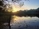 Scenic pond view at sunset with a wooden fence in the foreground at 100 Lakeside Dr, Covington, GA 30016