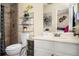 Bathroom featuring a shower, toilet, and a vanity sink with black and gold accents at 1236 Country Pine Dr, Ellenwood, GA 30294