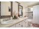 Bathroom featuring a double vanity and framed mirrors, plus a shower and toilet at 1236 Country Pine Dr, Ellenwood, GA 30294