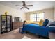 Relaxing bedroom with a TV, ceiling fan, and bed with blue comforter, plus bright natural light at 1236 Country Pine Dr, Ellenwood, GA 30294
