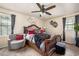 Bedroom featuring a cushioned headboard, a chair and ottoman, and natural lighting at 1236 Country Pine Dr, Ellenwood, GA 30294